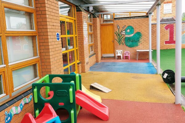 Exterior community hall garden with children's toys