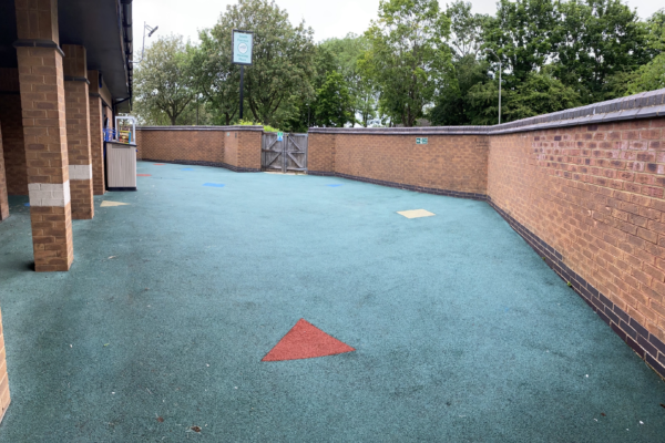 Wet-pour play surface in walled area of South Furzton Meeting Place