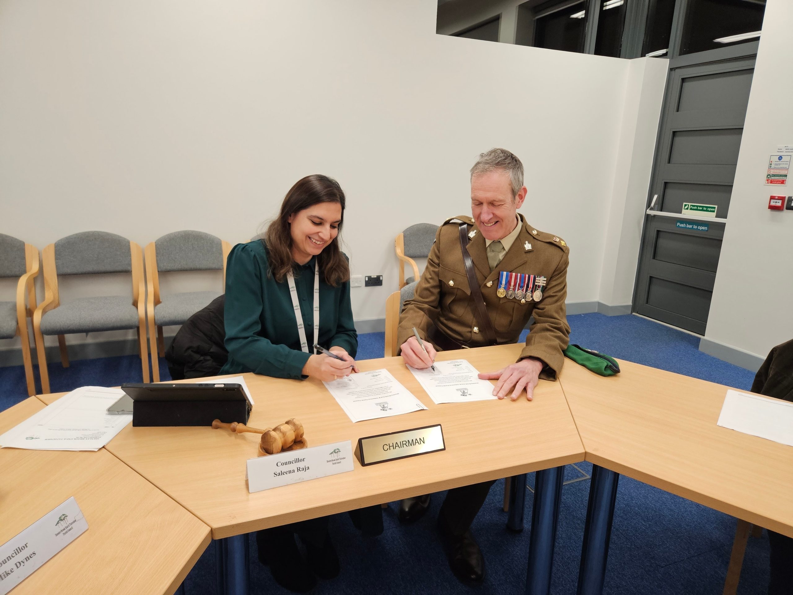 Parish Chair Saleena Raja and Lt Col Glenn Ridgley sign the Armed Forces Covenant