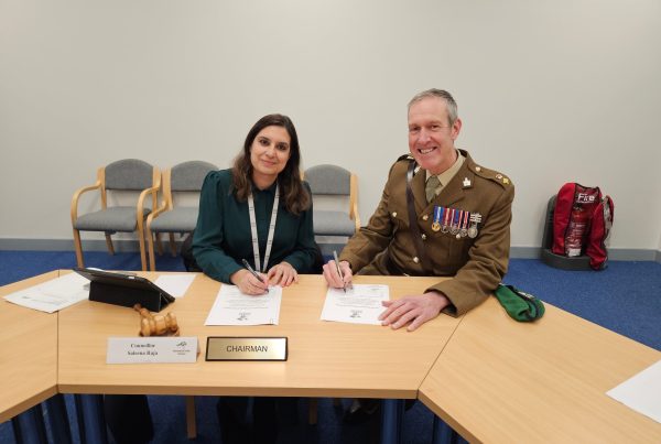 Parish Chair Saleena Raja and Lt Col Glenn Ridgley signing the Armed Forces Covenant